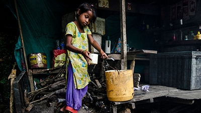 Young girl collects water.